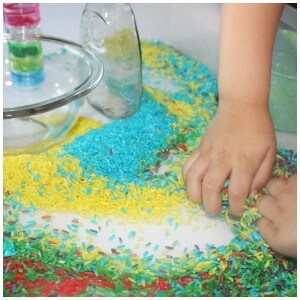 color rainbow rice sensory play mixing with hands
