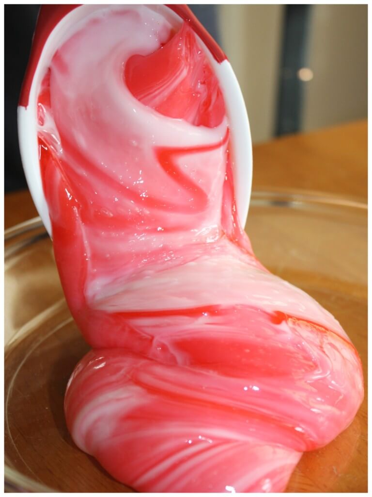 Candy Cane Slime recipe Pouring From Big Scoop