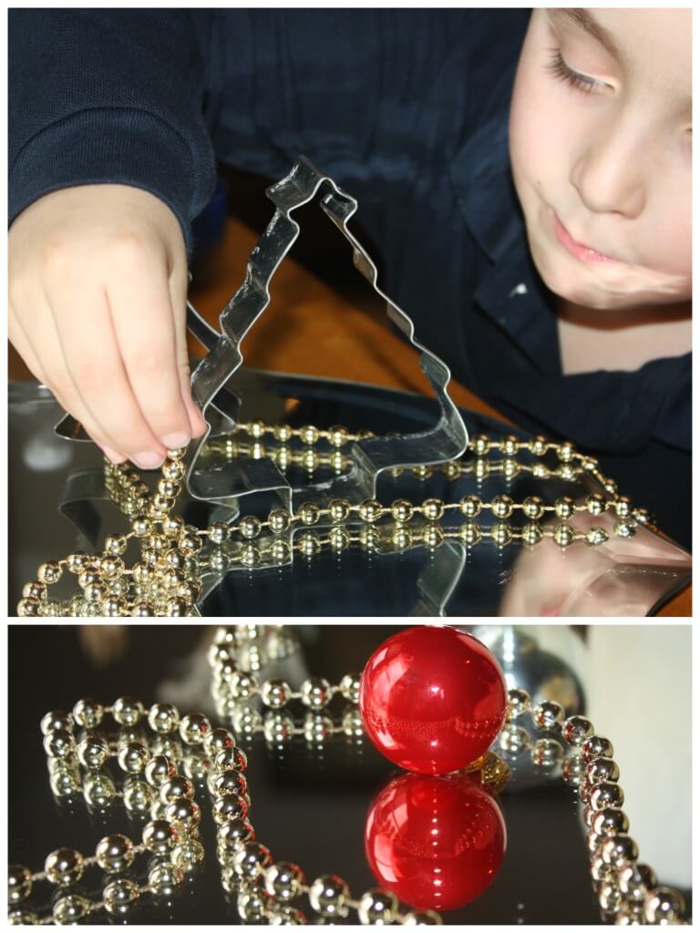 Christmas mirror play exploring string beads on mirror