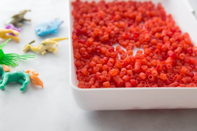 add sensory bin fillers to your colored pasta
