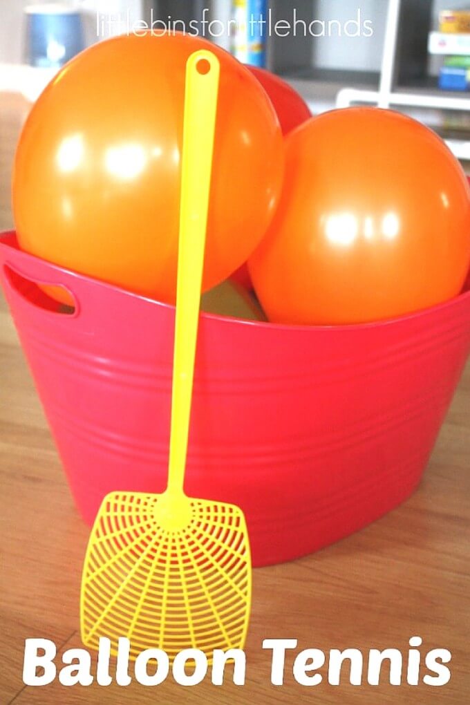 Set up balloon tennis for an easy, indoor, gross motor sensory play game any day! Perfect rainy day activity or energy buster idea to try with kids of all ages including adults! Use balloons and fly swatters to make your own indoor tennis game or party activity.