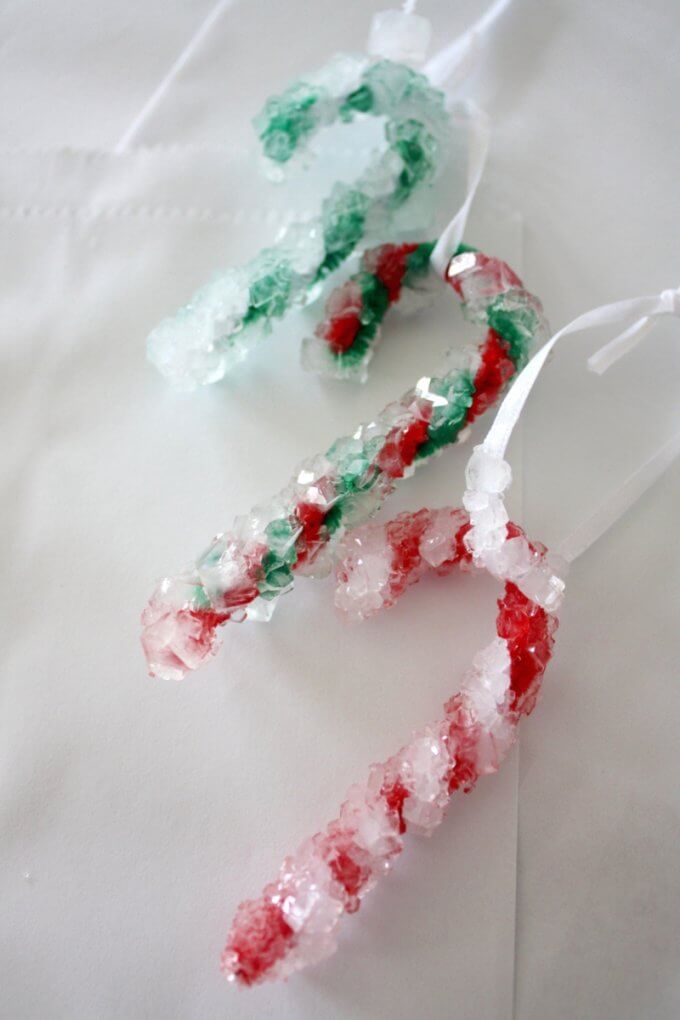 Check out this great science experiment for kids! They can learn how to grow crystal candy canes with a Christmas chemistry science activity! Fun experiment for kids! #STEM #science #candycane
