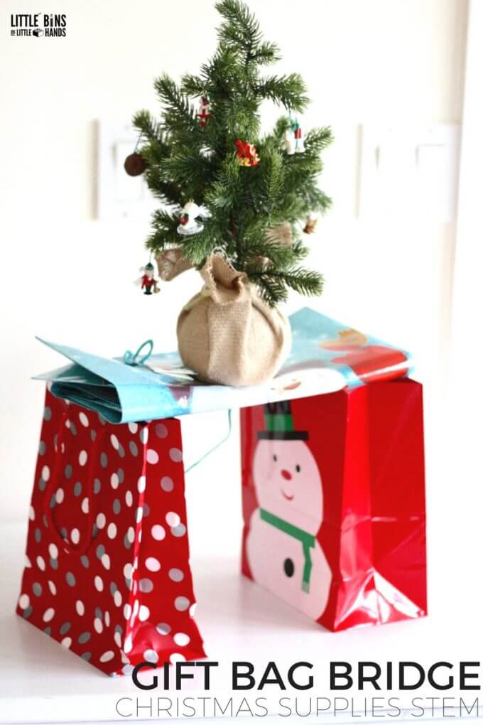 Christmas gift bag bridge engineering STEM challenge for holiday play and learning. Use common holiday supplies for quick and easy to set up Christmas STEM anytime.