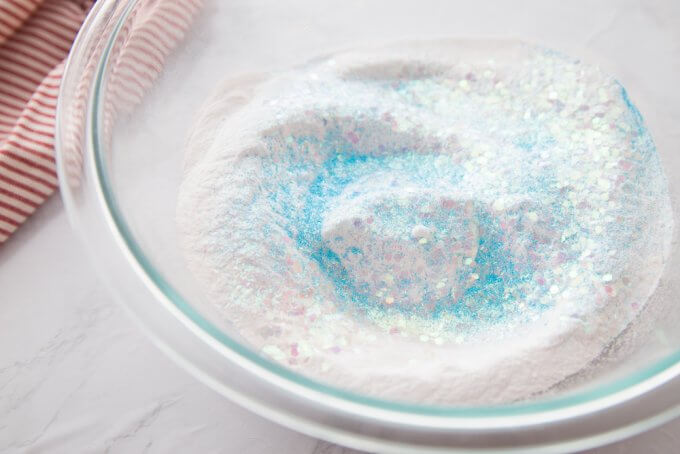 baking soda and glitter in a bowl waiting for water to be added to make melting snowmen