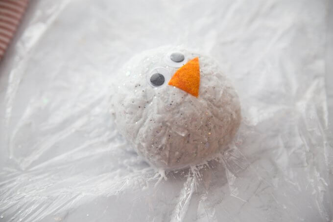 fizzing snowball snowman for winter science, use plastic wrap to help form snowball