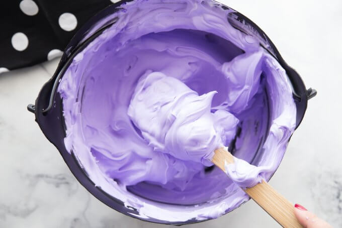 mixing glue and shaving cream with a wooden spoon