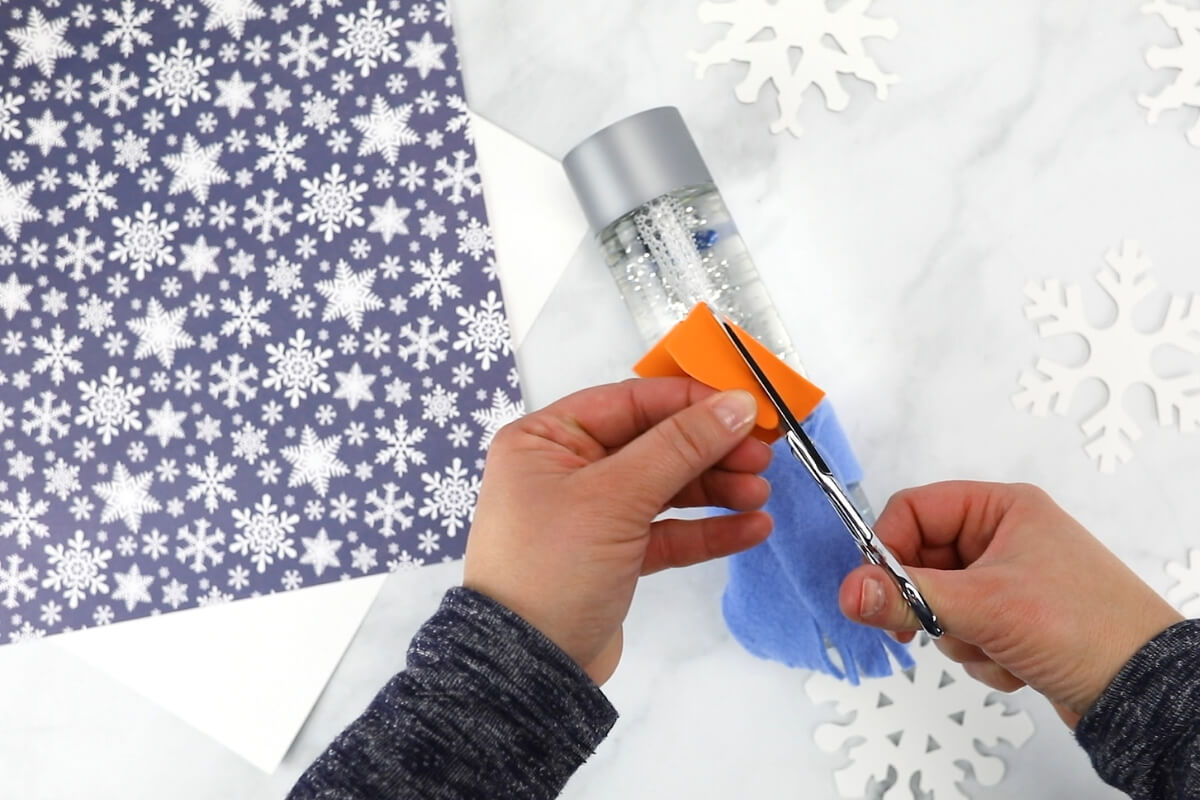 Cutting orange foam nose for snowman sensory bottle