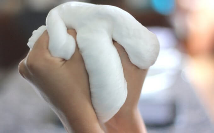 squeezing fluffy snow slime in hands