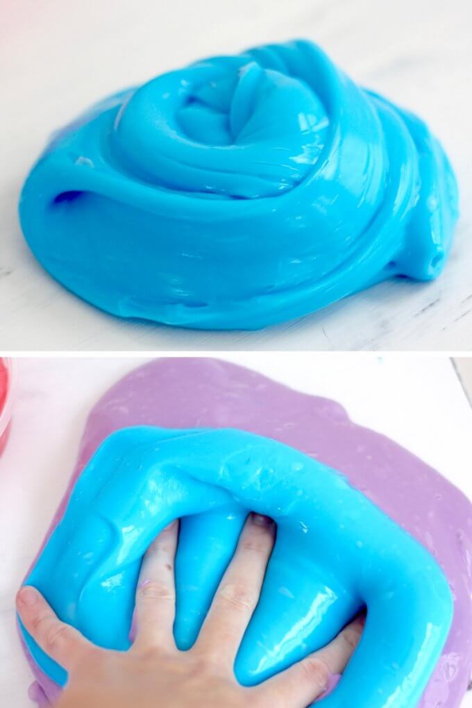 blue borax slime on table with hand squishing it