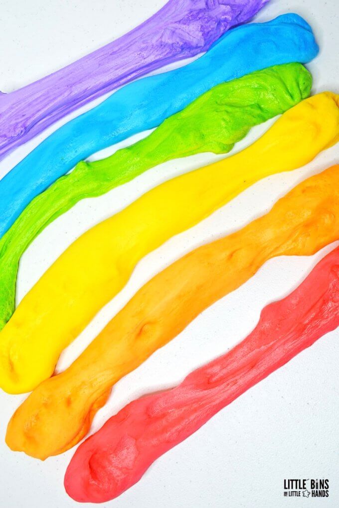strips of fluffy slime laid out on table in colors of rainbow