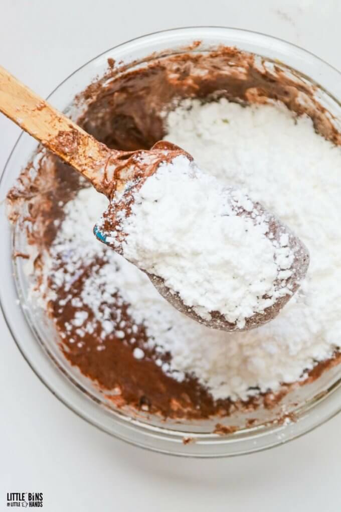 adding powder sugar to edible chocolate slime mixture