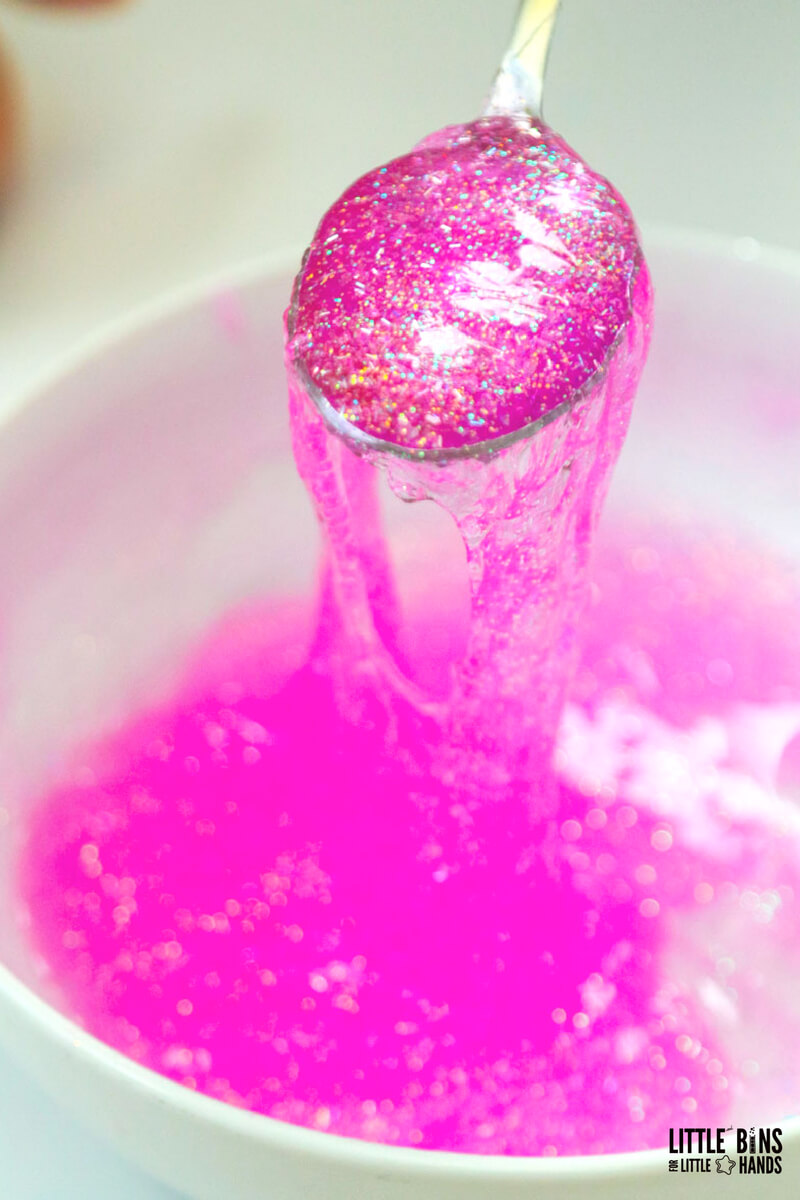 pink slime recipe - mixing elmers glitter glue with liquid starch in bowl with spoon