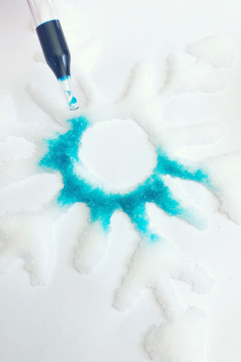 salt painting snowflakes absorbing colored water