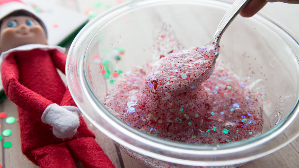 Mixing Christmas confetti slime for Elf on the Shelf slime