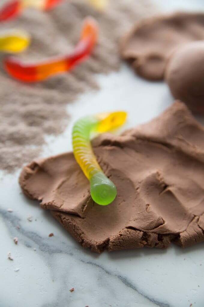 chocolate pudding slime with a gummy worm for taste-safe sensory play