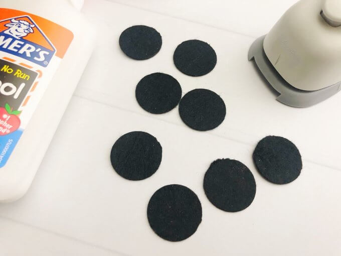 cut out black circles and glue them around the earth