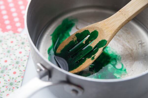 Add food coloring to the water and oil mixture.