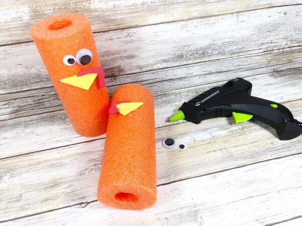Stick craft pieces to the pool noodle to make a face.