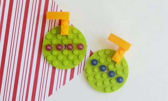 Two round ornaments made out of Legos.