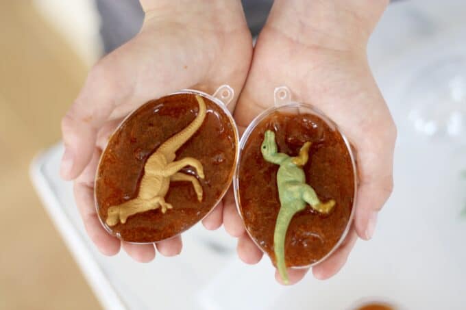 plastic dinosaurs in clear plastic eggs filled with homemade slime