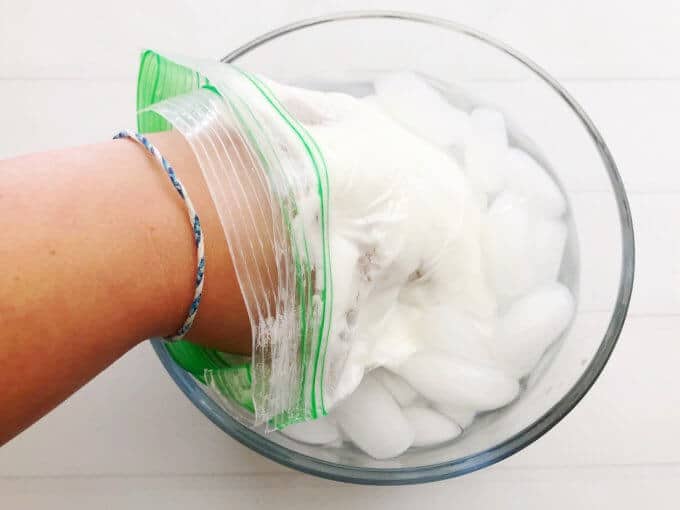 A hand in a bag of shortnening in a bowl of ice water showing how blubber works