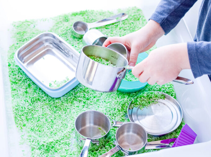 preschool measuring activity with cups and rice