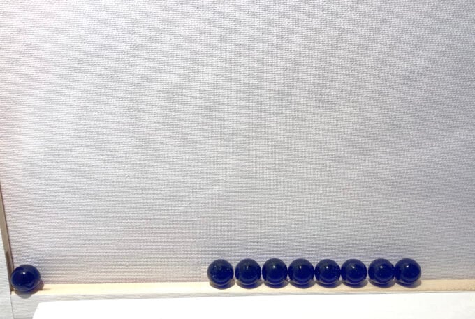 result of energy transfer from one marble rolled into the line of marbles